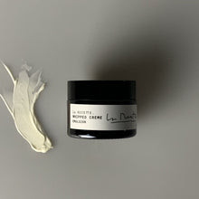 Load image into Gallery viewer, A dark glass jar with a white label that says Whipped Creme Emulsion in black elegant letters. on the left is a swipe of white face cream.