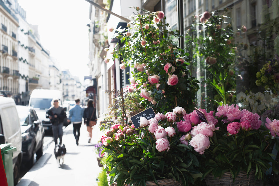 A photo of a Paris street with flowers